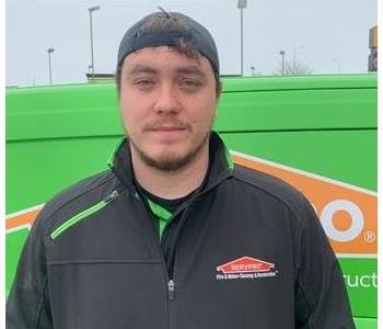 Restoration manager standing in front of SERVPRO van